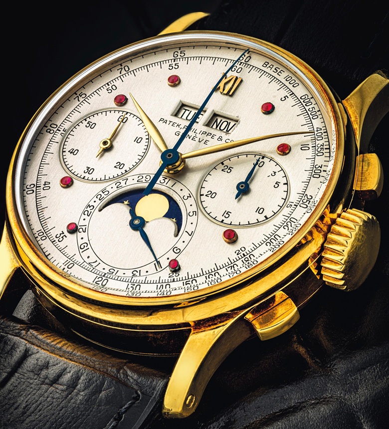 The gold and blue hands and rubies hour markers are striking on the ivory dial of fake Patek Philippe.
