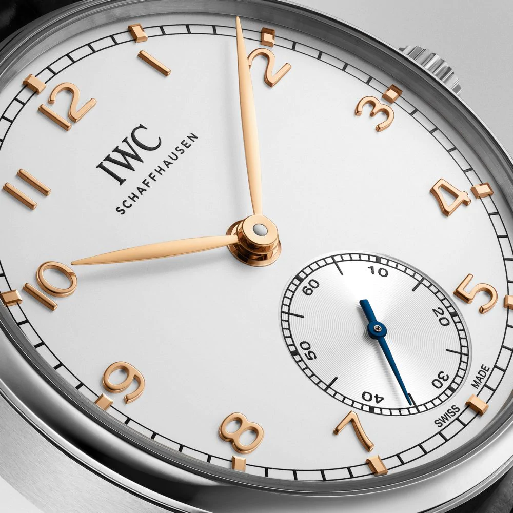The Arabic numerals hour markers and hands are striking on the white dial of fake IWC.
